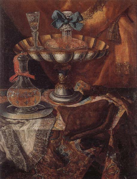 Still life of a wine glass and bottle in a parcel gilt tazza together with a glass decanter on a pewter dish upon a draped tabletop